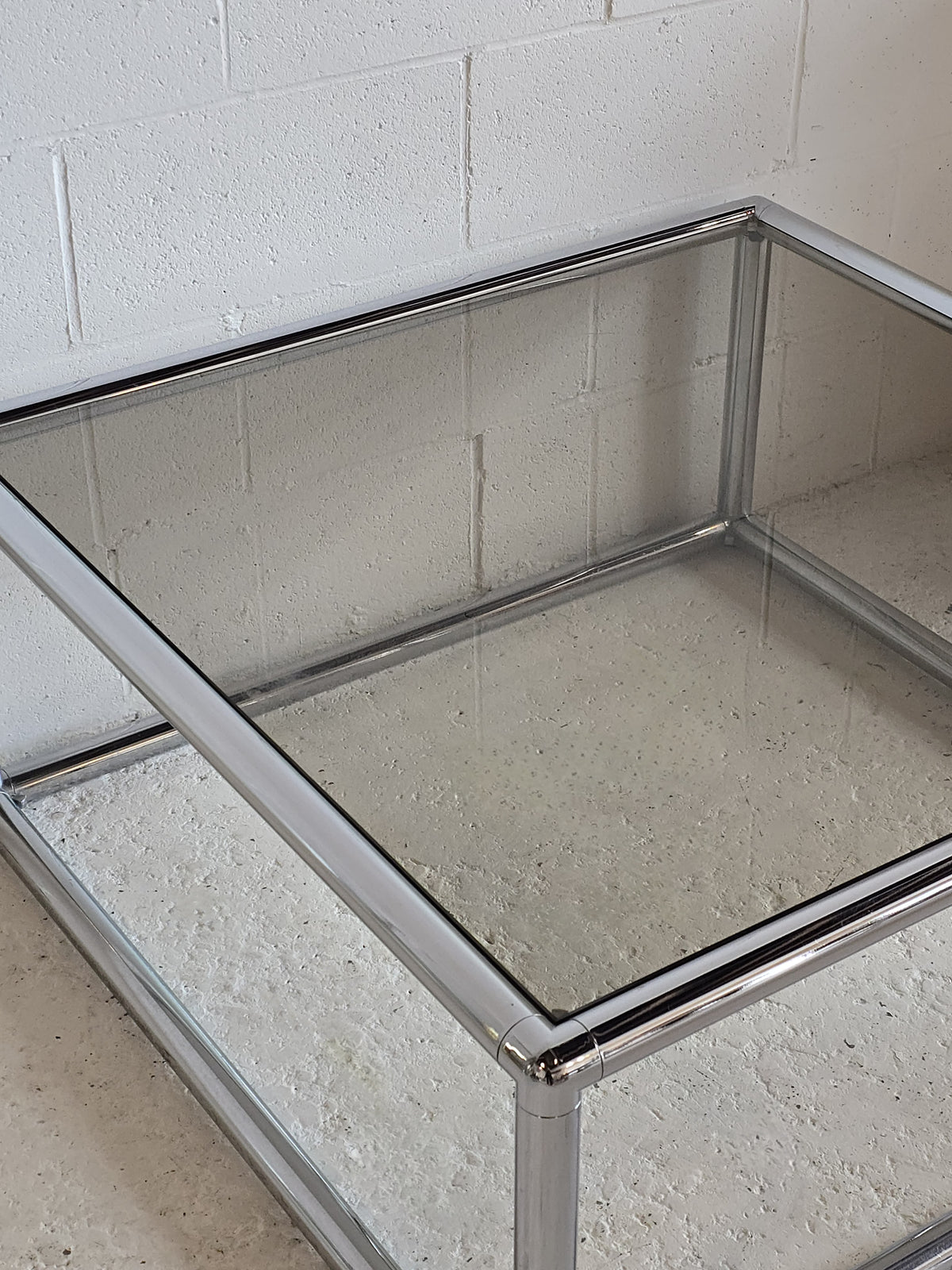 Tubular chrome and tinted glass coffee table