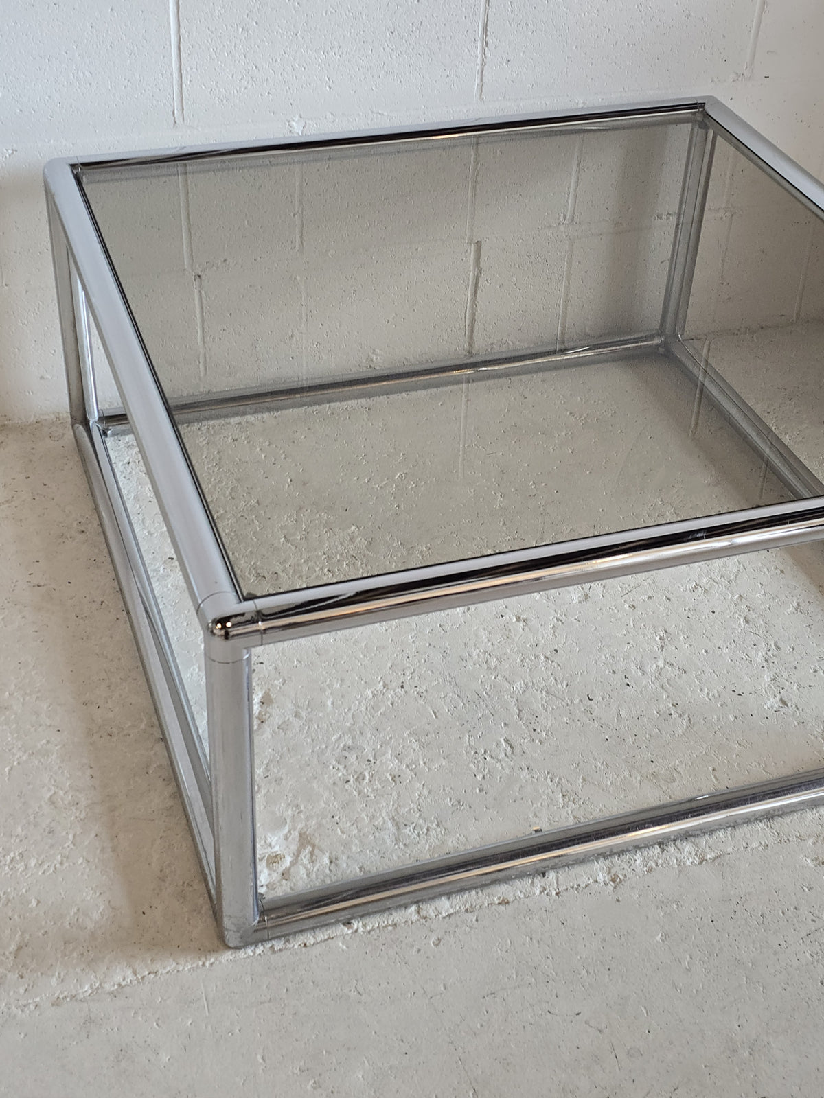 Tubular chrome and tinted glass coffee table