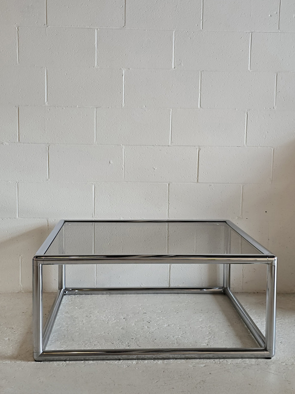 Tubular chrome and tinted glass coffee table