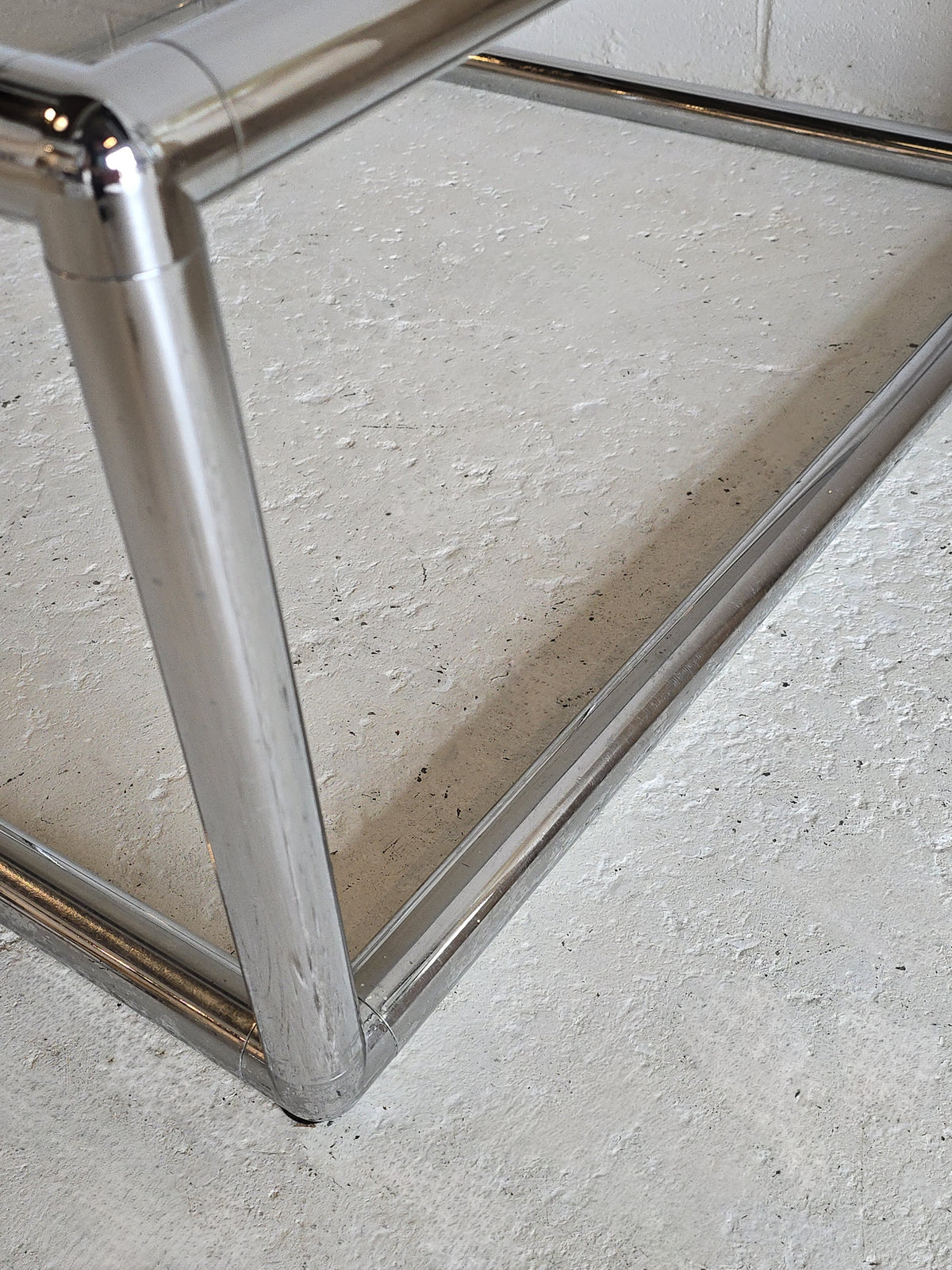 Tubular chrome and tinted glass coffee table