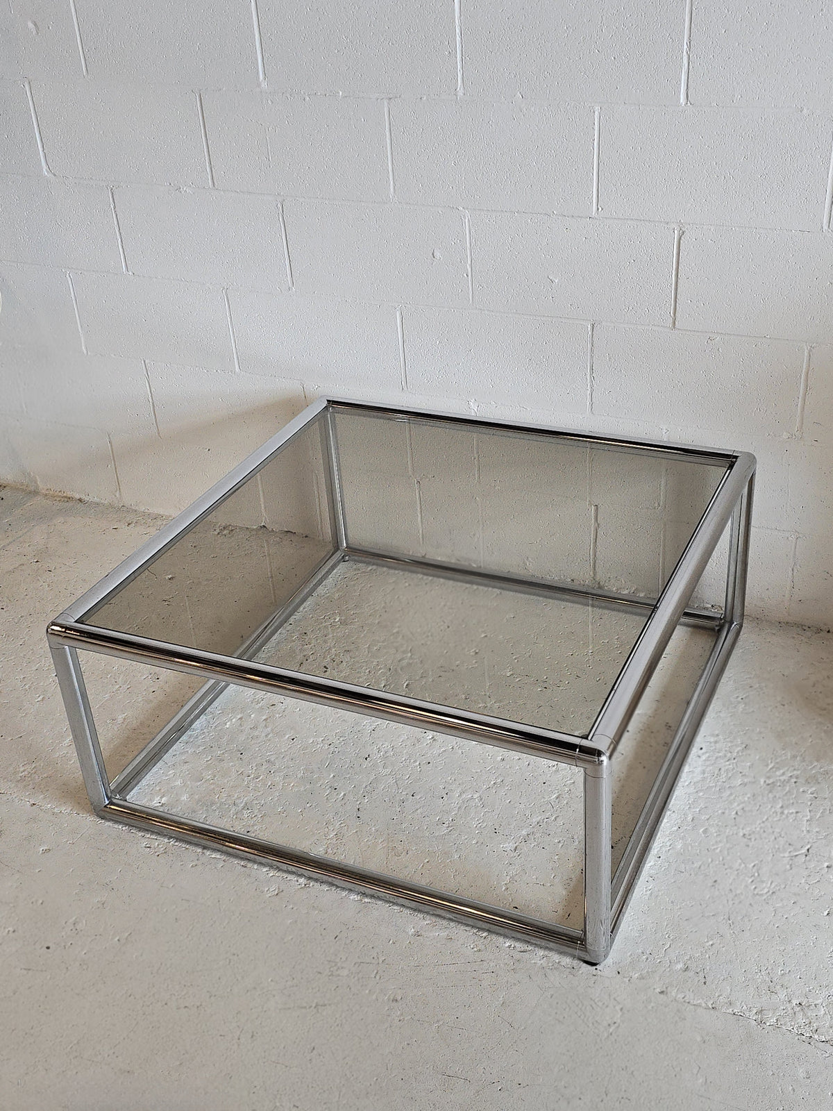 Tubular chrome and tinted glass coffee table
